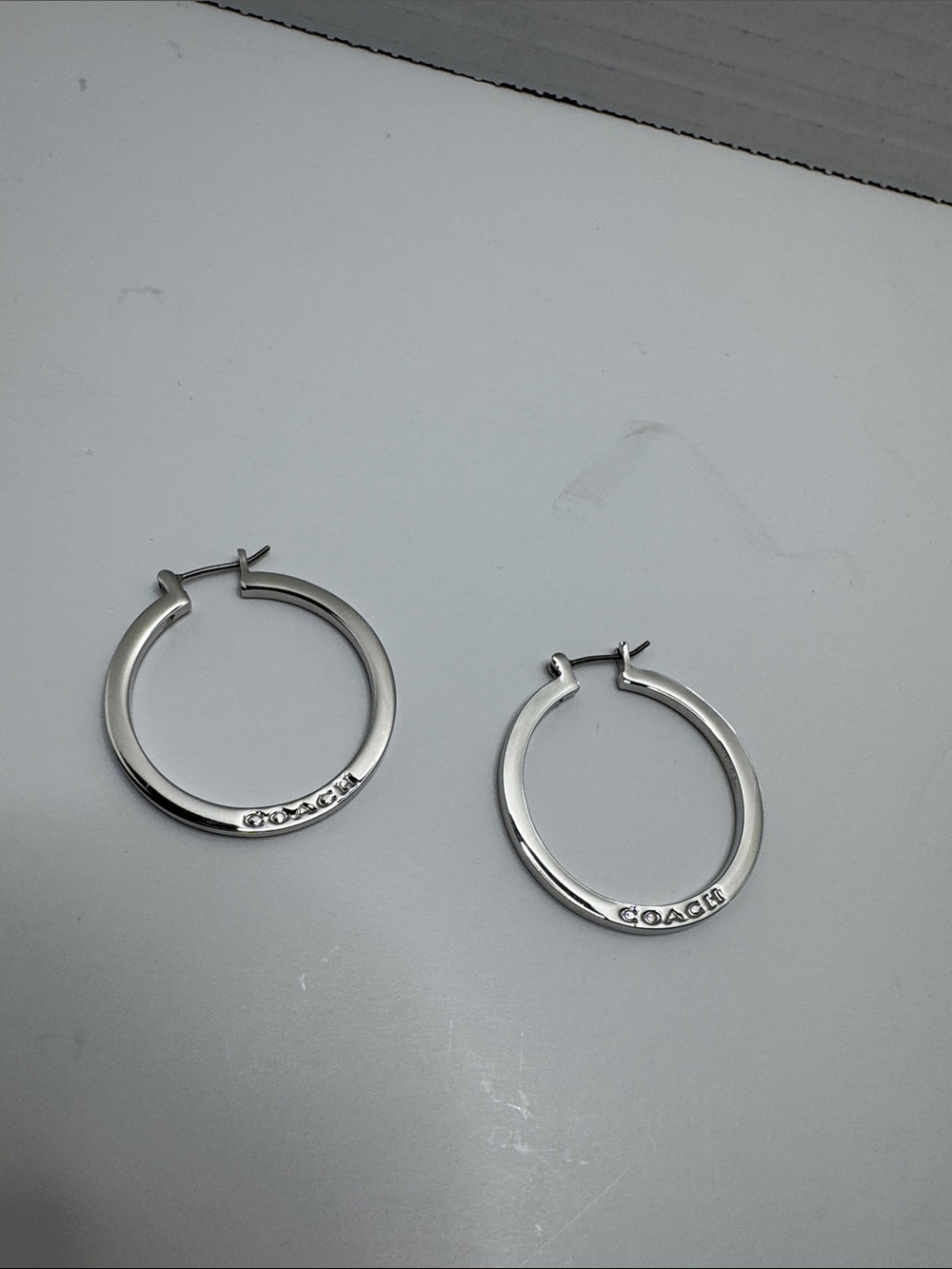 Coach Polished Silver Hoop Earrings with Logo Detail